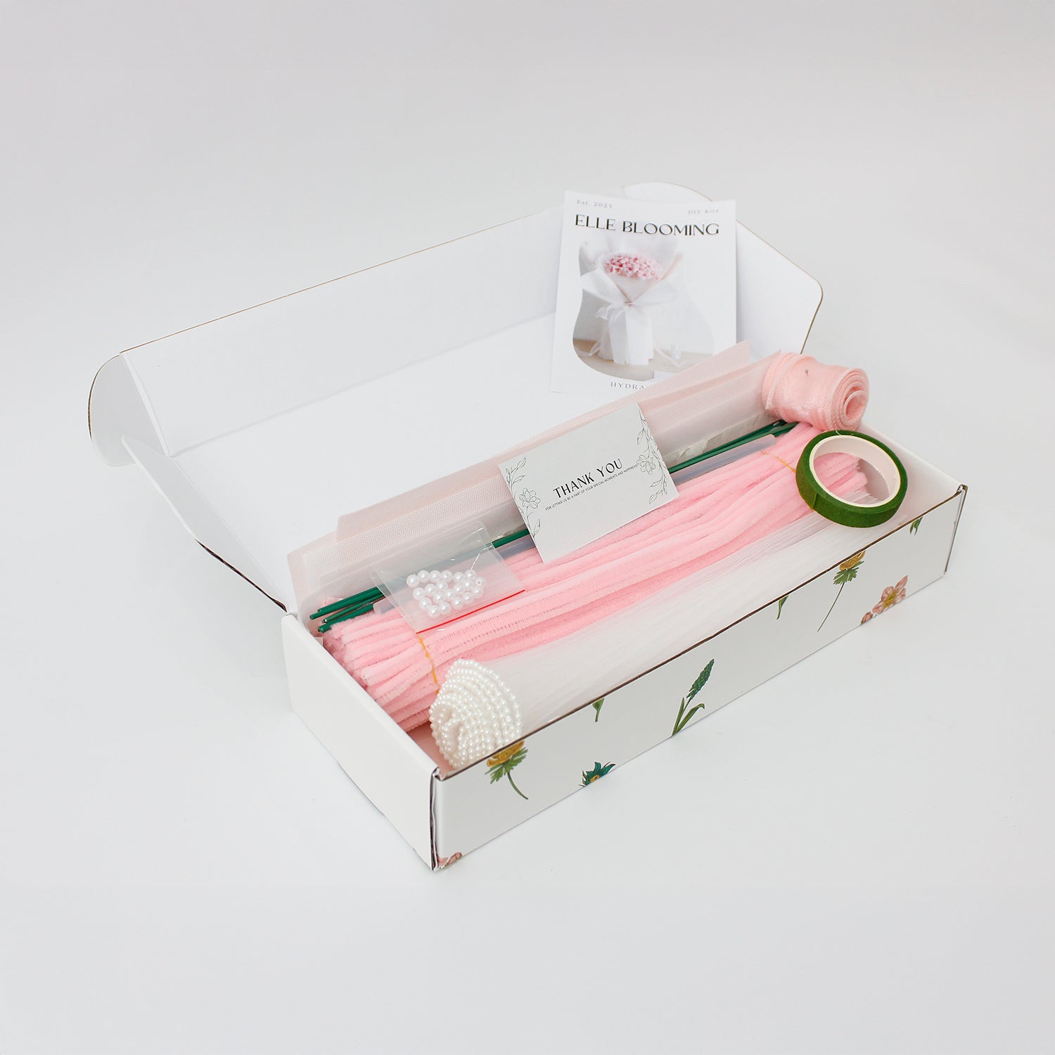 DIY bouquet of delicate pink hydrangea flowers, handmade from soft pipe cleaners with tiny pearl-like centers. Wrapped in soft pink and white paper with a sheer ribbon a dreamy handmade gift.