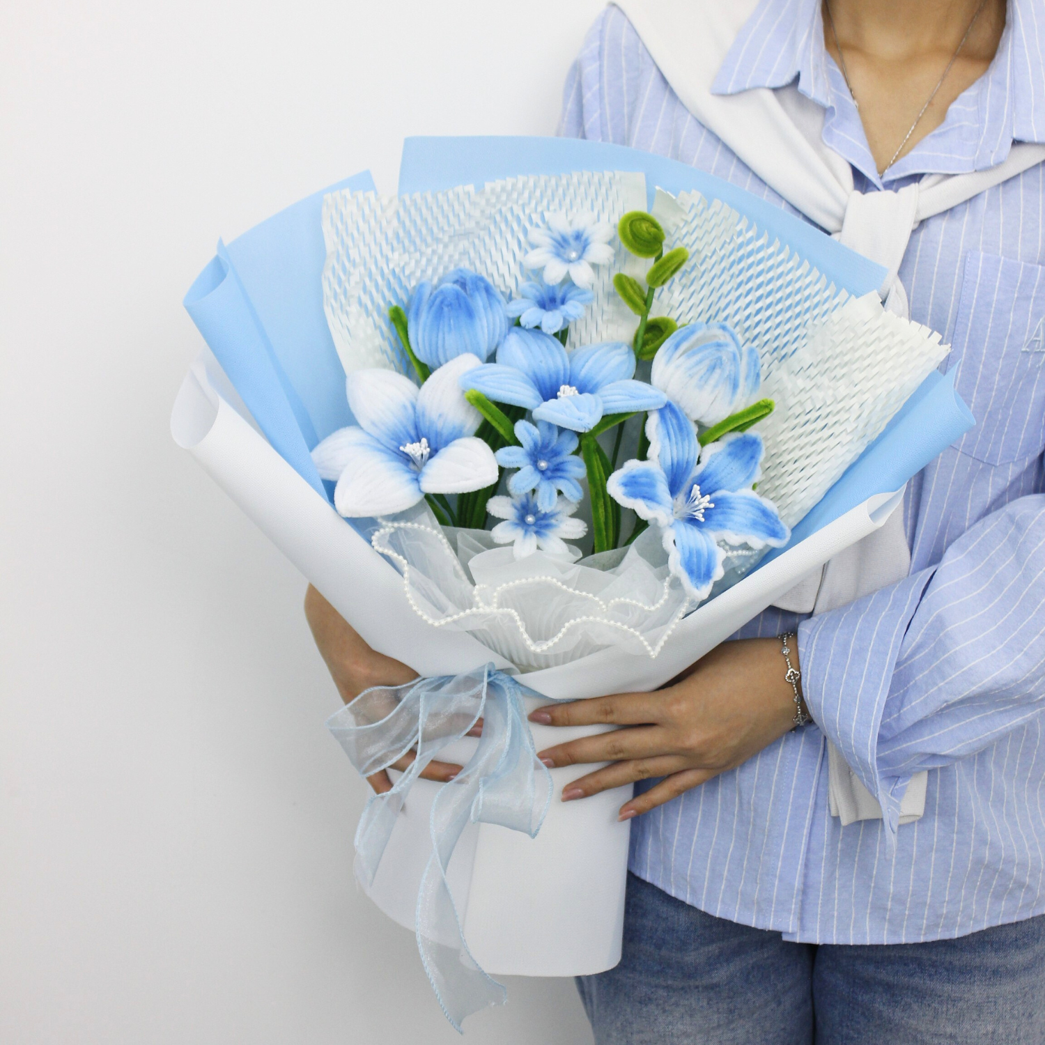 A handcrafted bouquet of baby blue cherish tiger lilies made from fuzzy pipe cleaners. Beautifully arranged and wrapped, perfect for gifting or elegant home decoration.