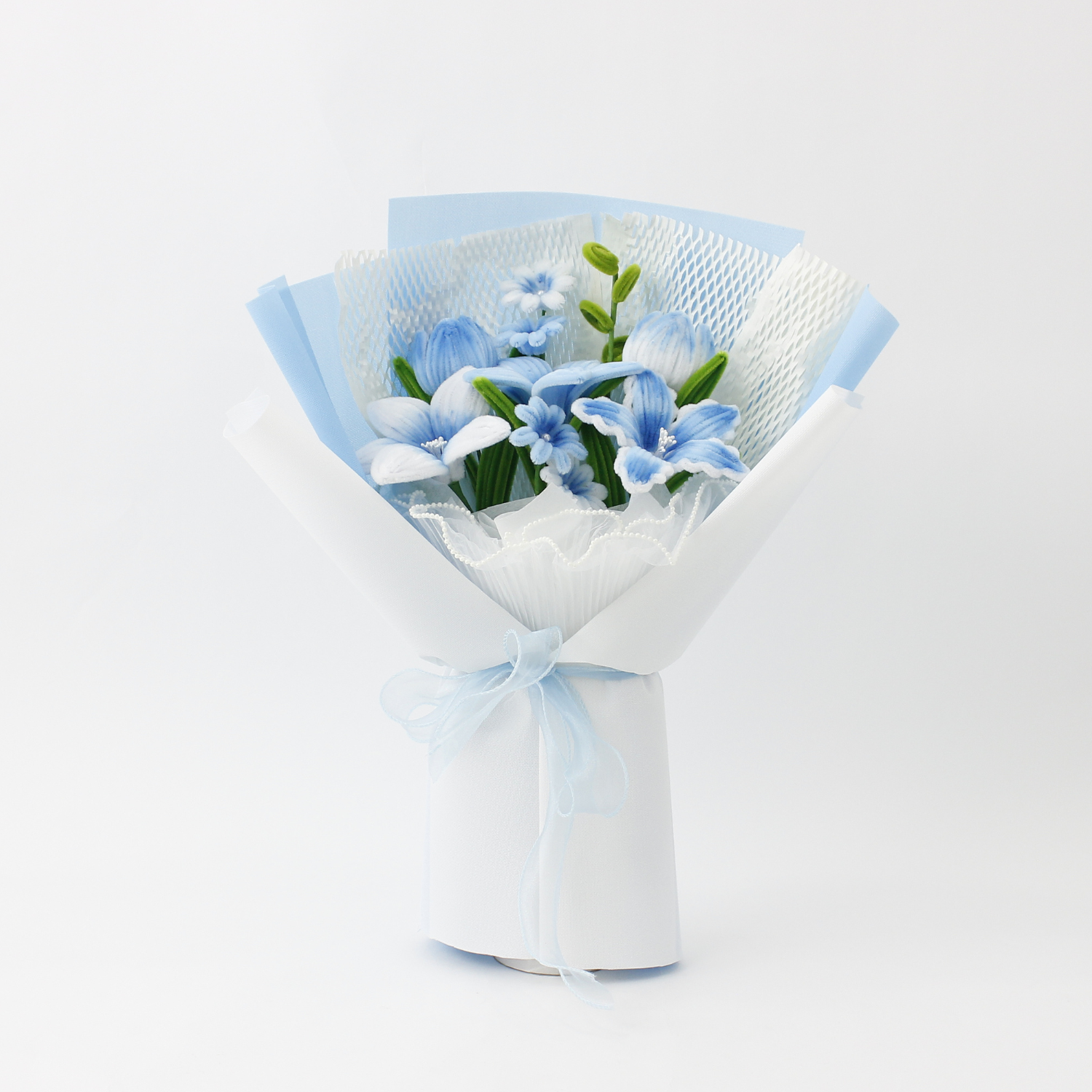 A handcrafted bouquet of baby blue cherish tiger lilies made from fuzzy pipe cleaners. Beautifully arranged and wrapped, perfect for gifting or elegant home decoration.