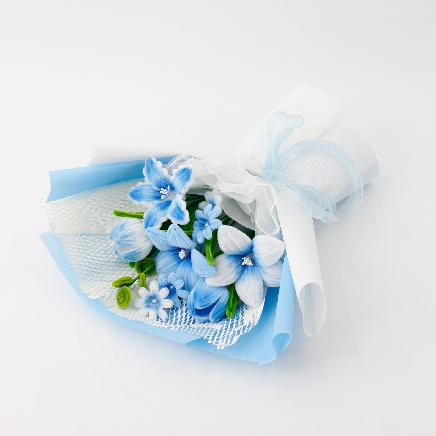 A handcrafted bouquet of baby blue cherish tiger lilies made from fuzzy pipe cleaners. Beautifully arranged and wrapped, perfect for gifting or elegant home decoration.