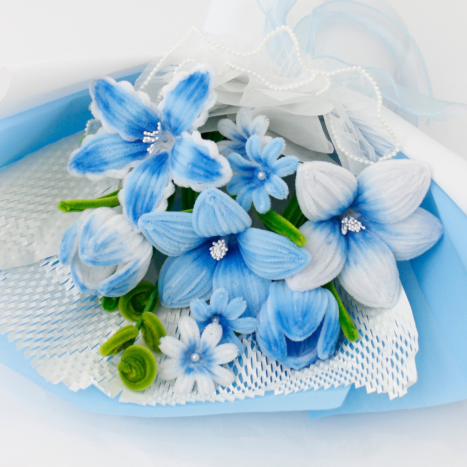 A handcrafted bouquet of baby blue cherish tiger lilies made from fuzzy pipe cleaners. Beautifully arranged and wrapped, perfect for gifting or elegant home decoration.