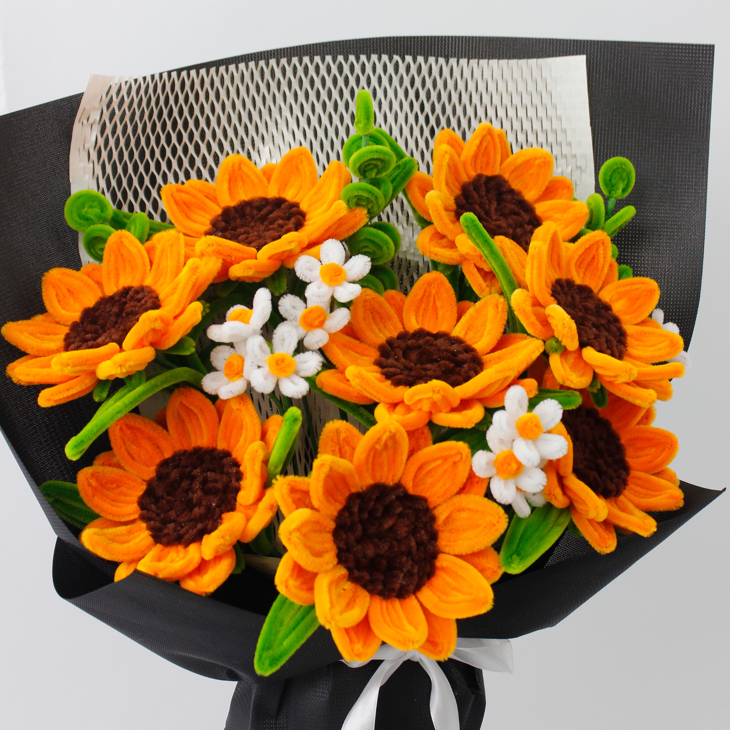 Handcrafted orange sunflower bouquet made from fuzzy pipe cleaners, styled with delicate white blooms. A perfect handmade gift or aesthetic decor piece for flower lovers.
