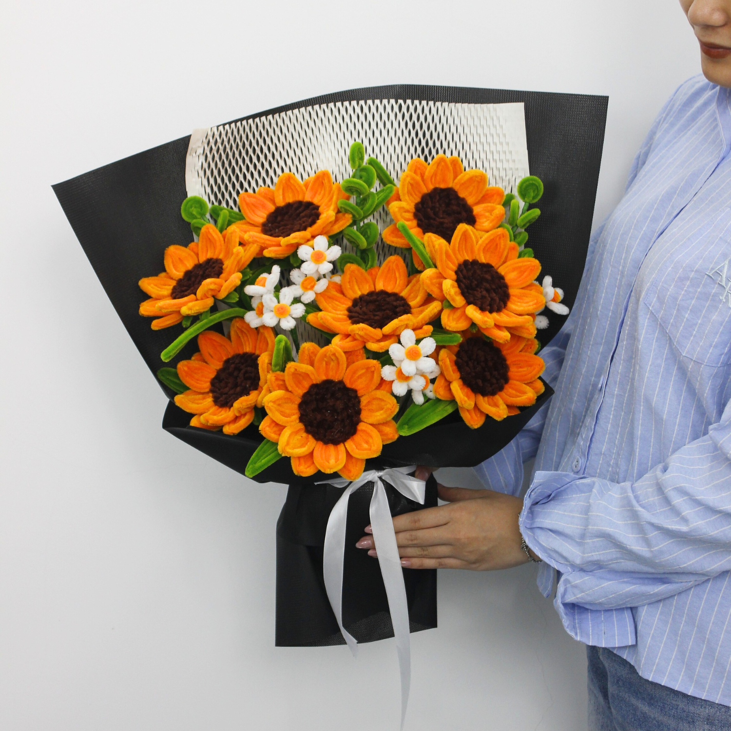 Handcrafted orange sunflower bouquet made from fuzzy pipe cleaners, styled with delicate white blooms. A perfect handmade gift or aesthetic decor piece for flower lovers.
