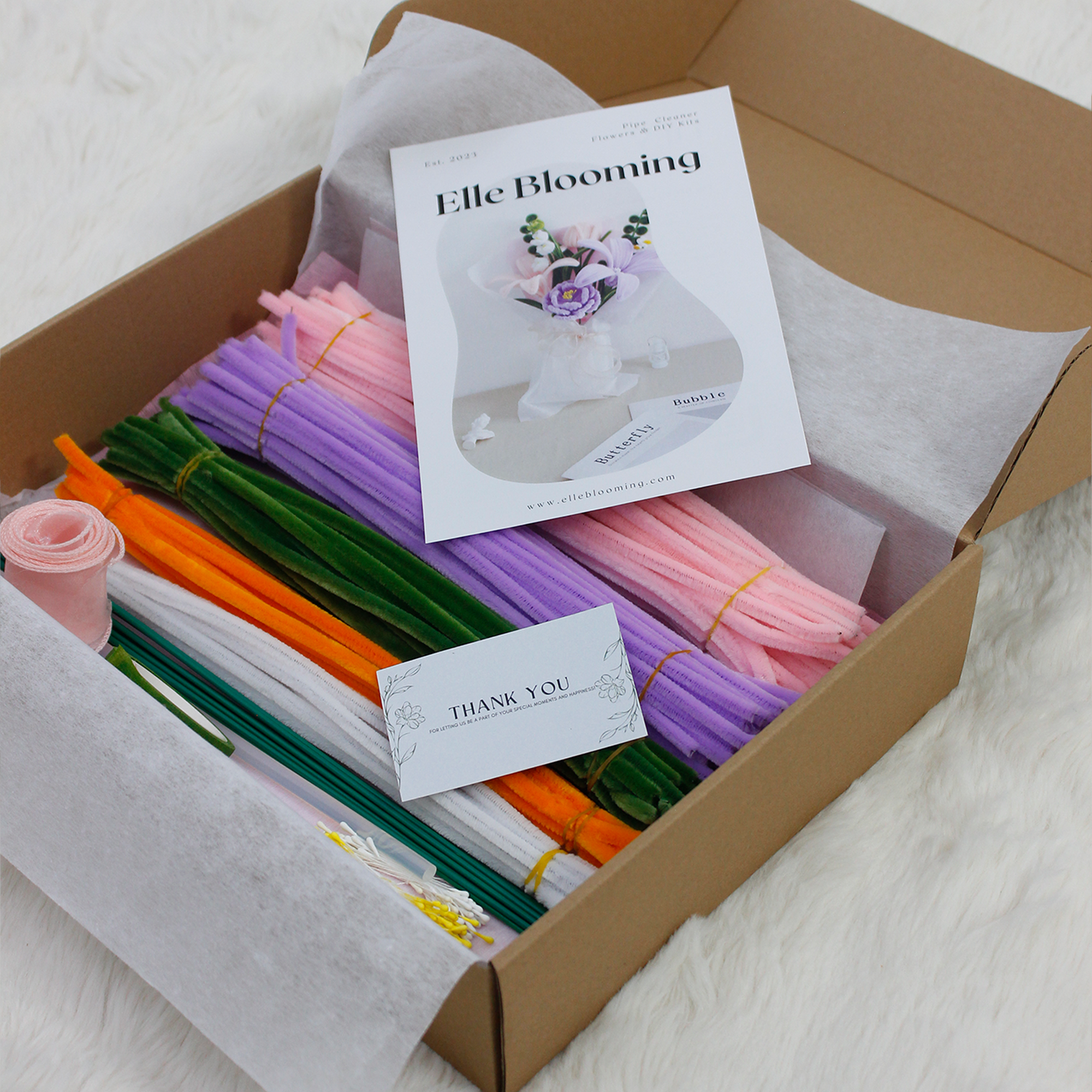 Pastel pipe cleaner bouquet DIY kit with lilies and daisies, complete with wrapping paper and crafting tools — perfect for handmade gifts and relaxing flower craft time.

