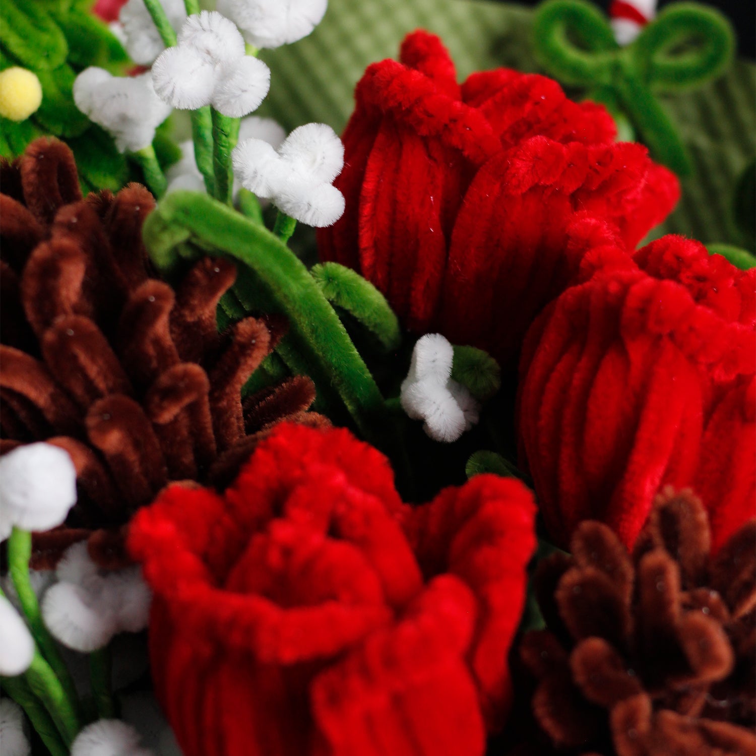 Handmade bouquet with green and white pipe cleaner flowers, wrapped in rich dark green paper and ribbon. Elegant evergreen design perfect for Christmas and winter décor.