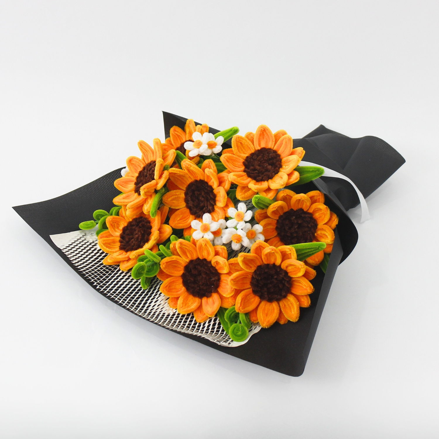 Person holding a bouquet of orange sunflowers and white flowers against a white background