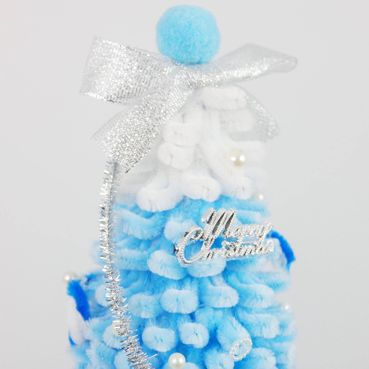Ombre blue and white pipe cleaner Christmas tree with silver bow and tinsel—perfect for winter holiday home decoration or gifts.