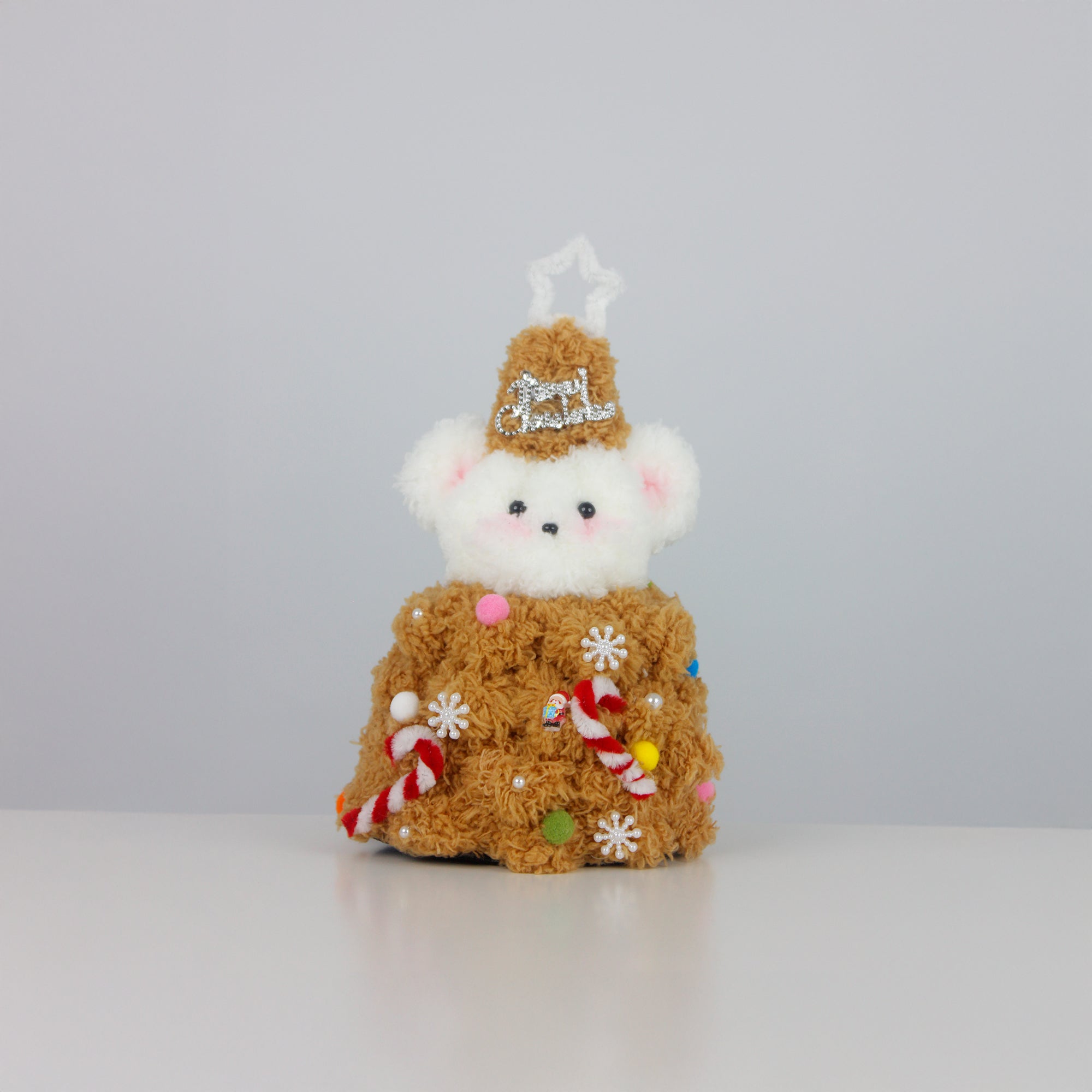 White bear dressed in a gingerbread brown outfit made from fuzzy pipe cleaners, decorated with candy canes and snowflakes. Ideal handmade Christmas gift.