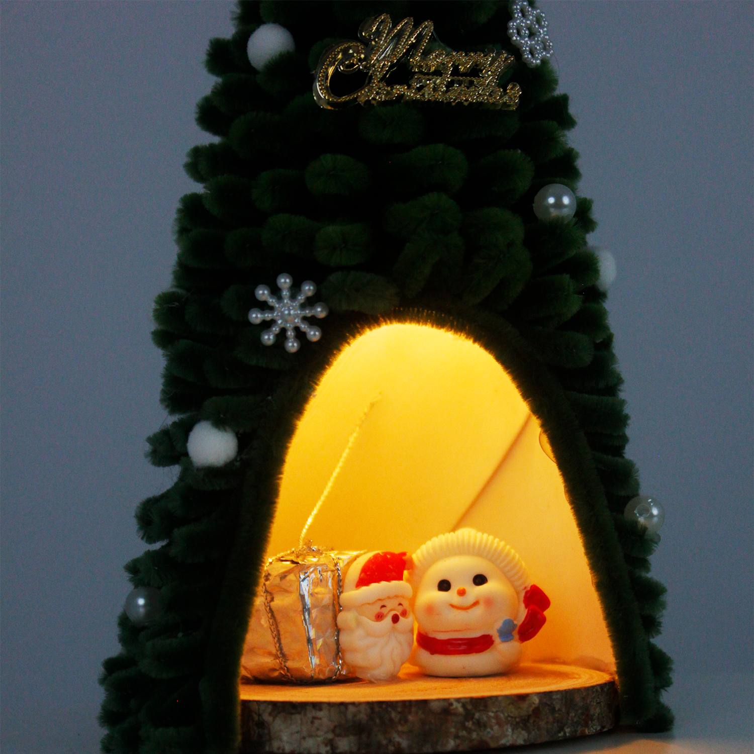  Pipe cleaner Christmas tree featuring Santa and snowman figurines with gift box inside, topped with red bow – ideal cute and cozy holiday decor.