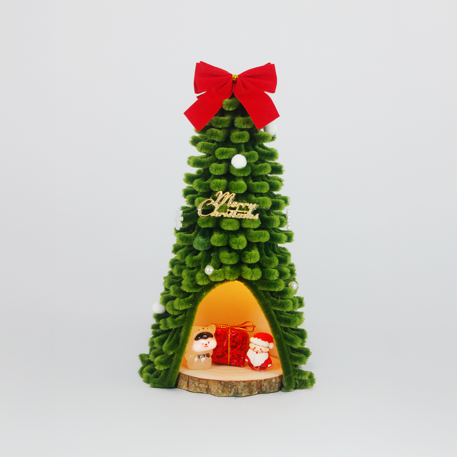 Green fuzzy wire Christmas tree featuring Santa Claus and pig figurine inside, topped with red bow – unique and charming holiday decor