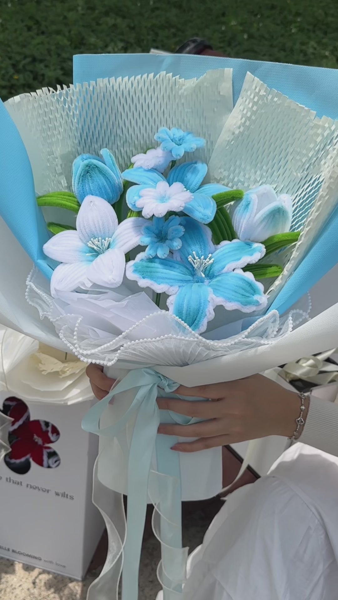 A handcrafted bouquet of baby blue cherish tiger lilies made from fuzzy pipe cleaners. Beautifully arranged and wrapped, perfect for gifting or elegant home decoration.